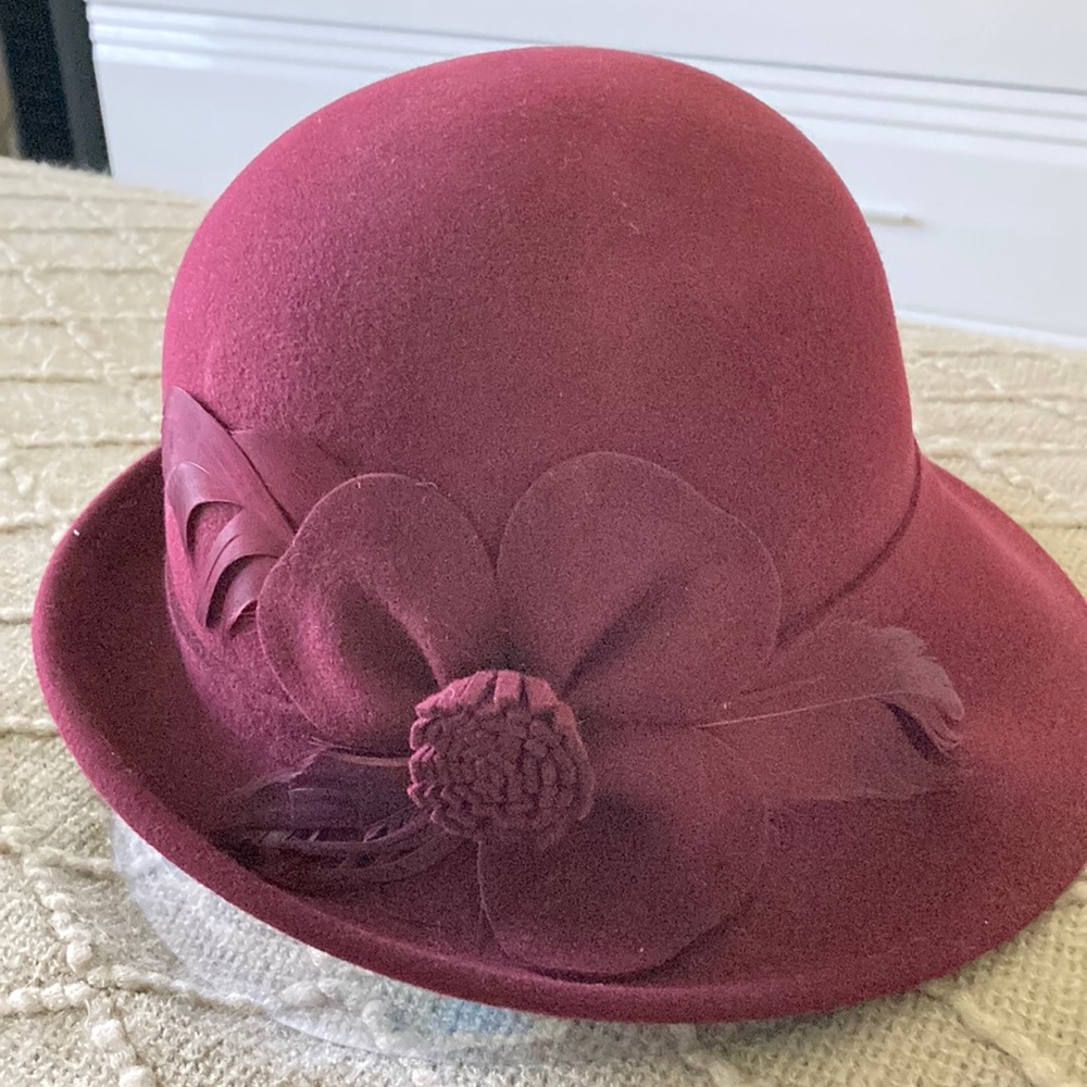 Burgundy hat with feather and flower